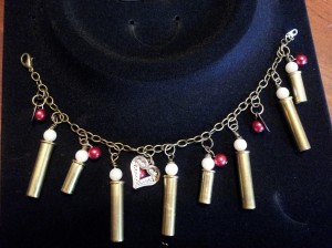 Bracelet with heart charm, red beads, 22lr casing with pearl beads.