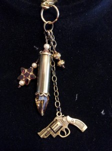 Bullet keychain with revolver charm, heart and brass beads.